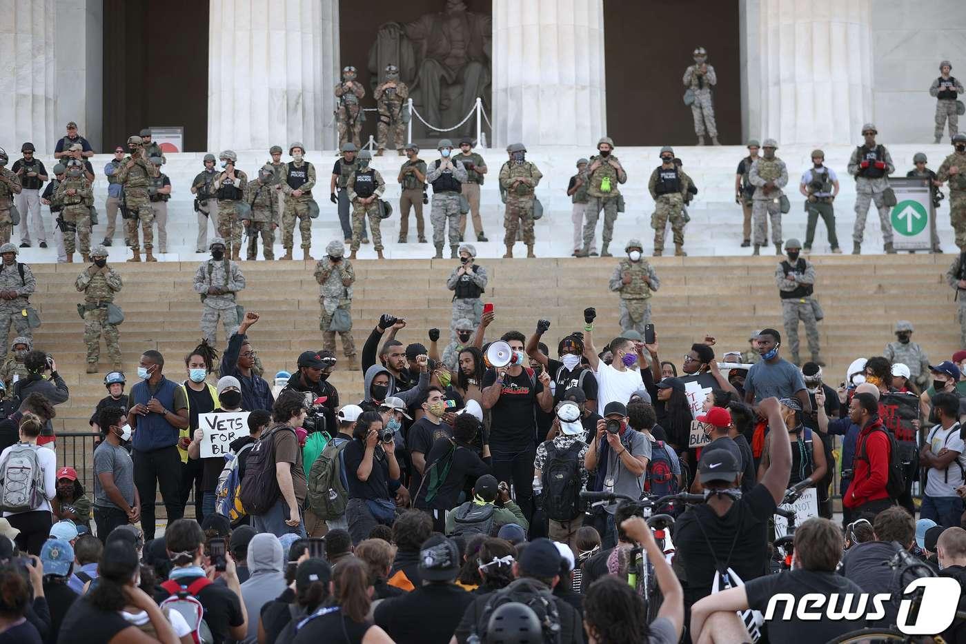 2일(현지시간) 워싱턴 링컨 기념관 계단에서 흑인 남성 조지 플로이드의 사망에 항의하는 시위대와 경찰들이 대치를 하고 있다. ⓒ AFP=뉴스1 ⓒ News1 우동명 기자