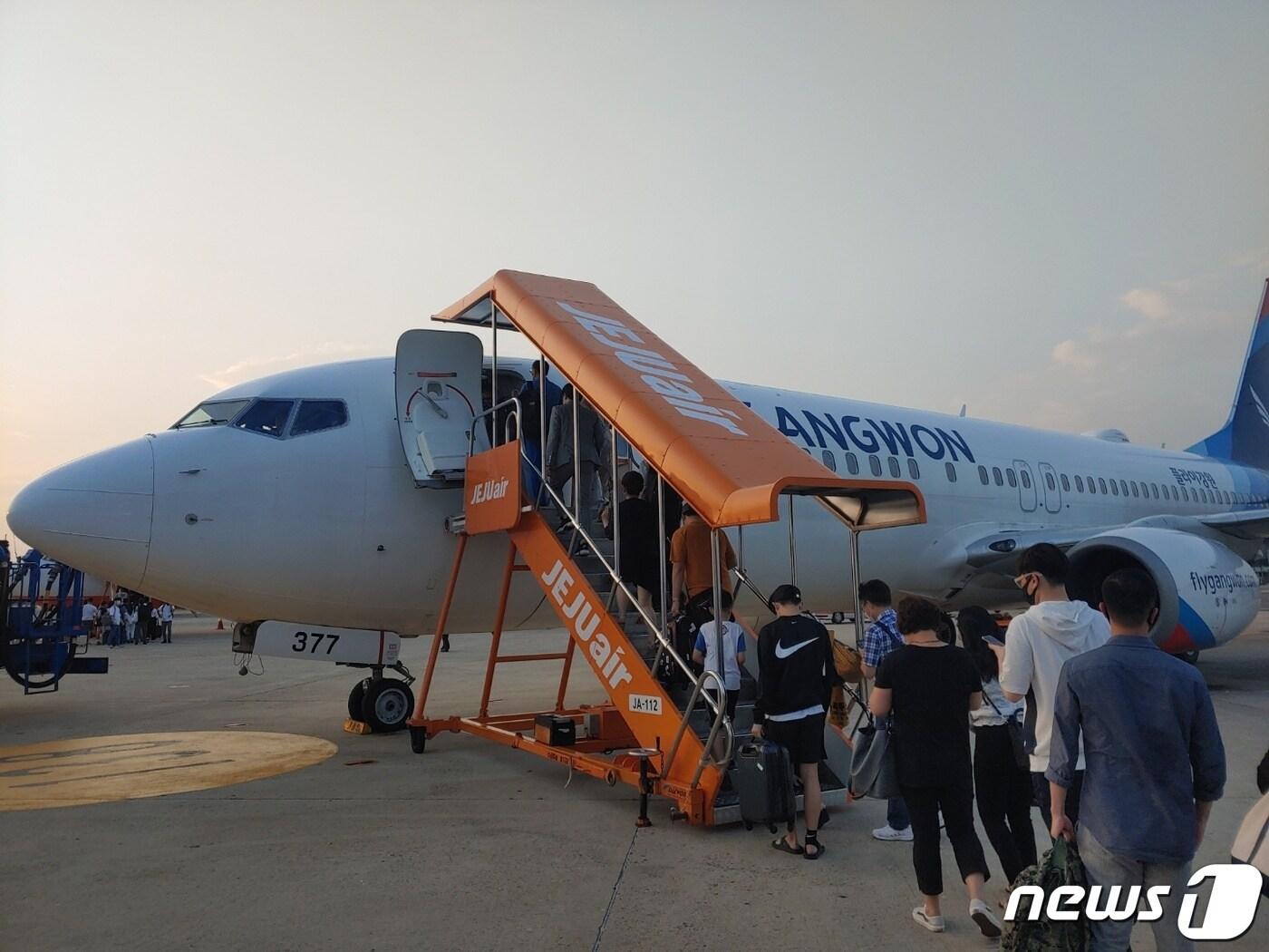 본문 이미지 - 지난 17일 첫 취항한 플라이강원의 김포~양양 노선 항공기에 승객들이 탑승하고 있다. ⓒ 뉴스1