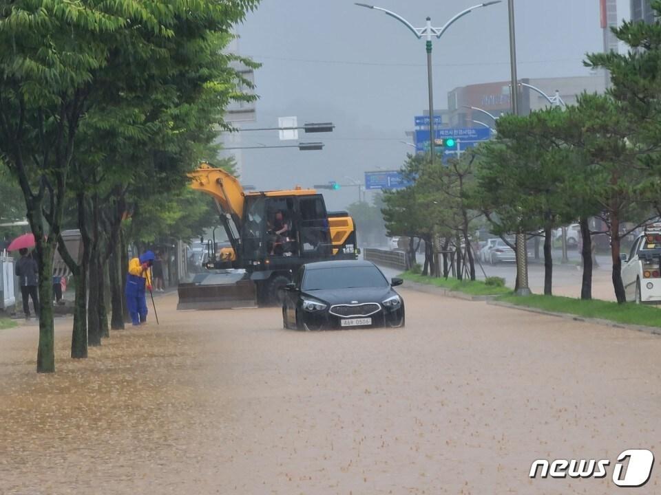 본문 이미지 - 2일 내린 폭우로 제천시 강제동 명지초등학교 앞 도로가 침수되면서 이곳을 지나던 차량이 고장나 구조를 기다리고 있다.2020.8.2 /ⓒ 뉴스1 조영석기자