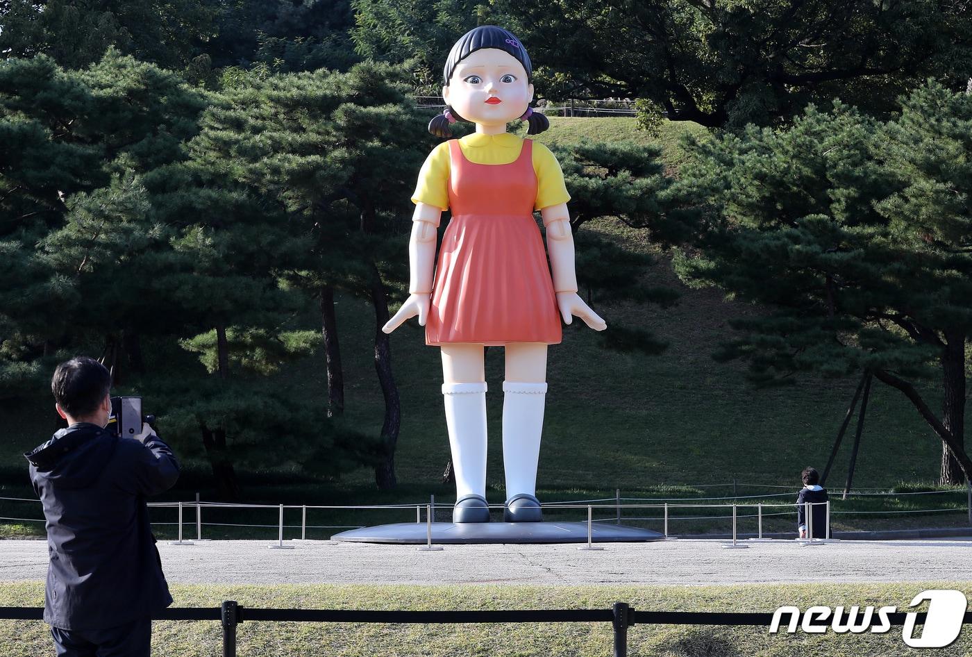 25일 오후 서울 송파구 올림픽공원 야외 88잔디마당에 설치된 넷플릭스 드라마 ‘오징어게임’ 영희 로봇 동상이 시민들 눈길을 끌고 있다. 2021.10.25/뉴스1 ⓒ News1 박세연 기자