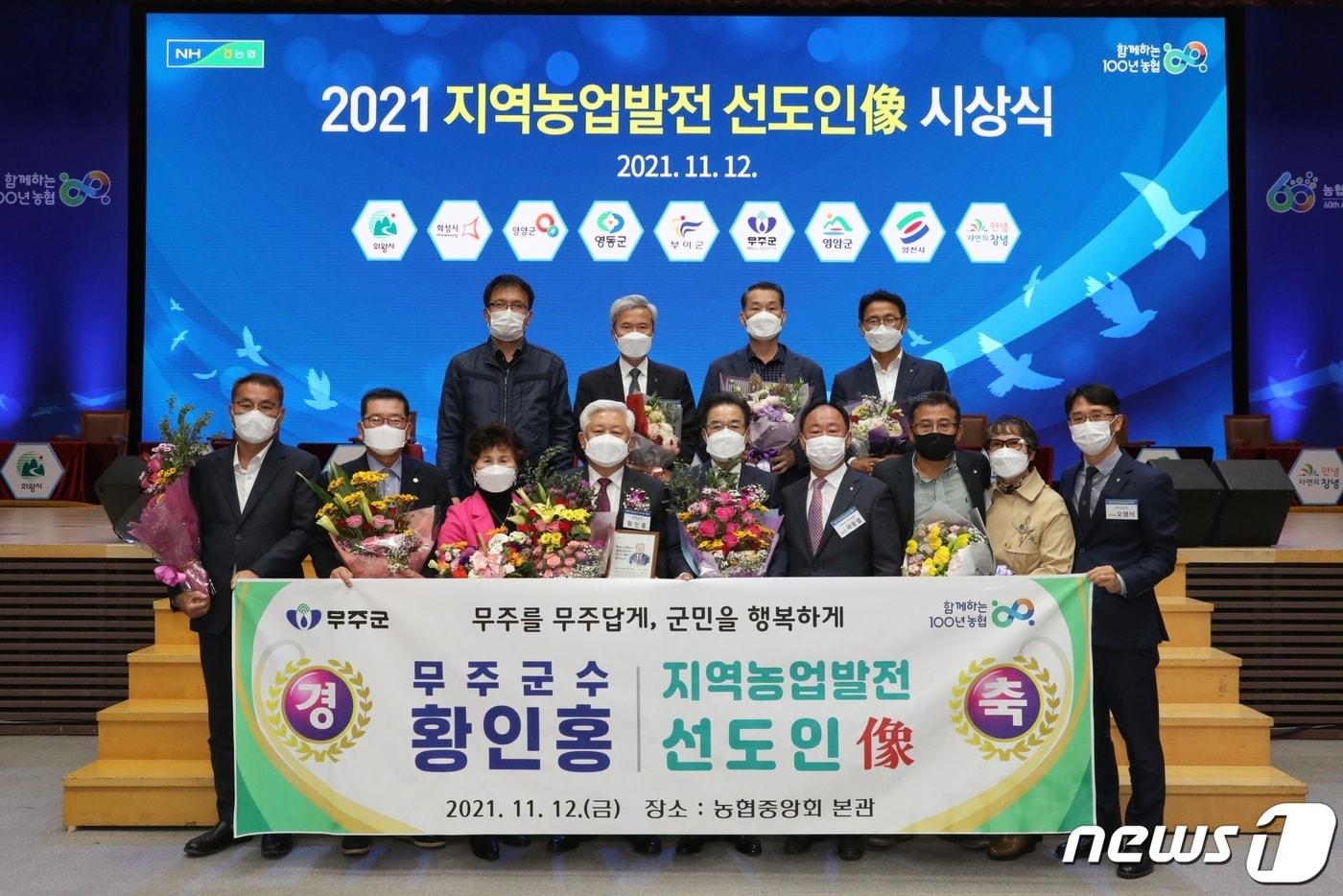 본문 이미지 - 황인홍 전북 무주군수(앞쪽 줄 왼쪽부터 4번째)가 12일 서울 중구 농업중앙회 본관 대강당에서 ‘지역농업발전 선도인상’을 수상한 뒤 기념사진을 찍고 있다(무주군 제공)2021.11.12/뉴스1