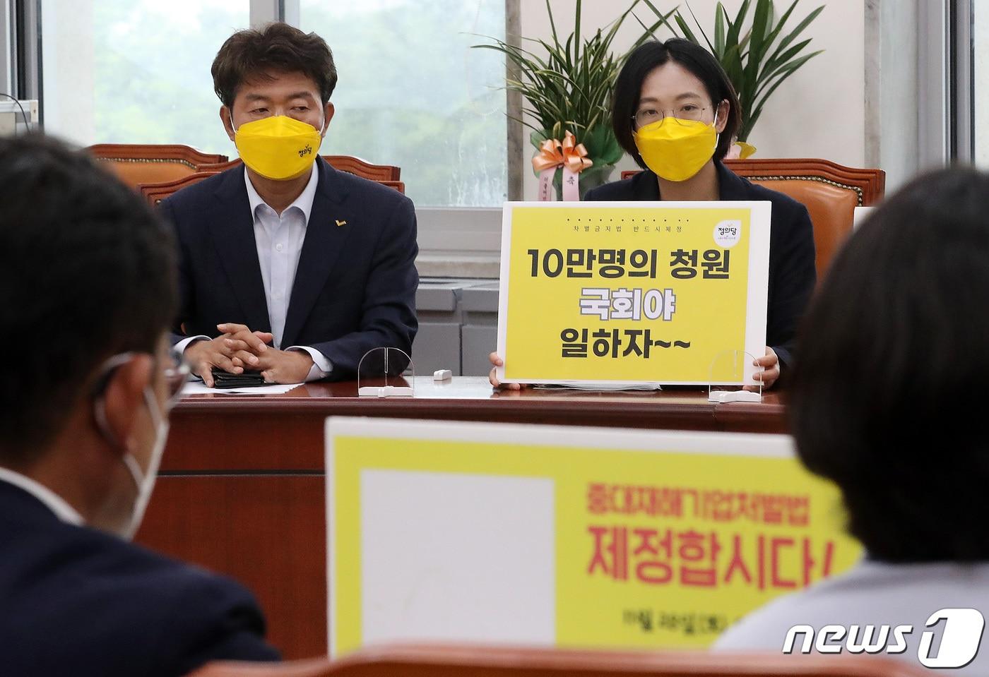 본문 이미지 - 여영국 정의당 대표(왼쪽0와 차별금지법을 대표 발의한 장혜영 의원이 지난달 15일 서울 여의도 국회에서 열린 '차별금지법 10만서명 보고 및 입법촉구' 기자회견에서 손 피켓을 들고 있다. 2021.6.15/뉴스1 ⓒ News1 이동해 기자