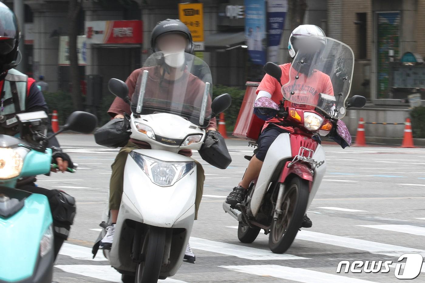  서울 광화문 네거리에서 배달 대행업체 라이더들이 음식을 배달하고 있다 지난 11일 배.2021.7.12/뉴스1 ⓒ News1 성동훈 기자