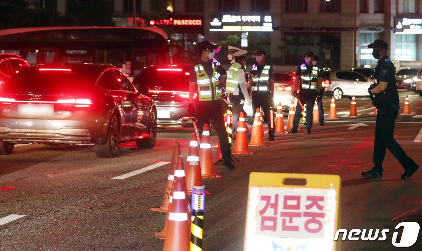 본문 이미지 - 경찰이 7월14일 오후 서울 여의도 서강대교 남단에서 국회 둔치주차장으로 향하는 차량을 검문하고 있다.  2021.7.14/뉴스1 ⓒ News1 김명섭 기자