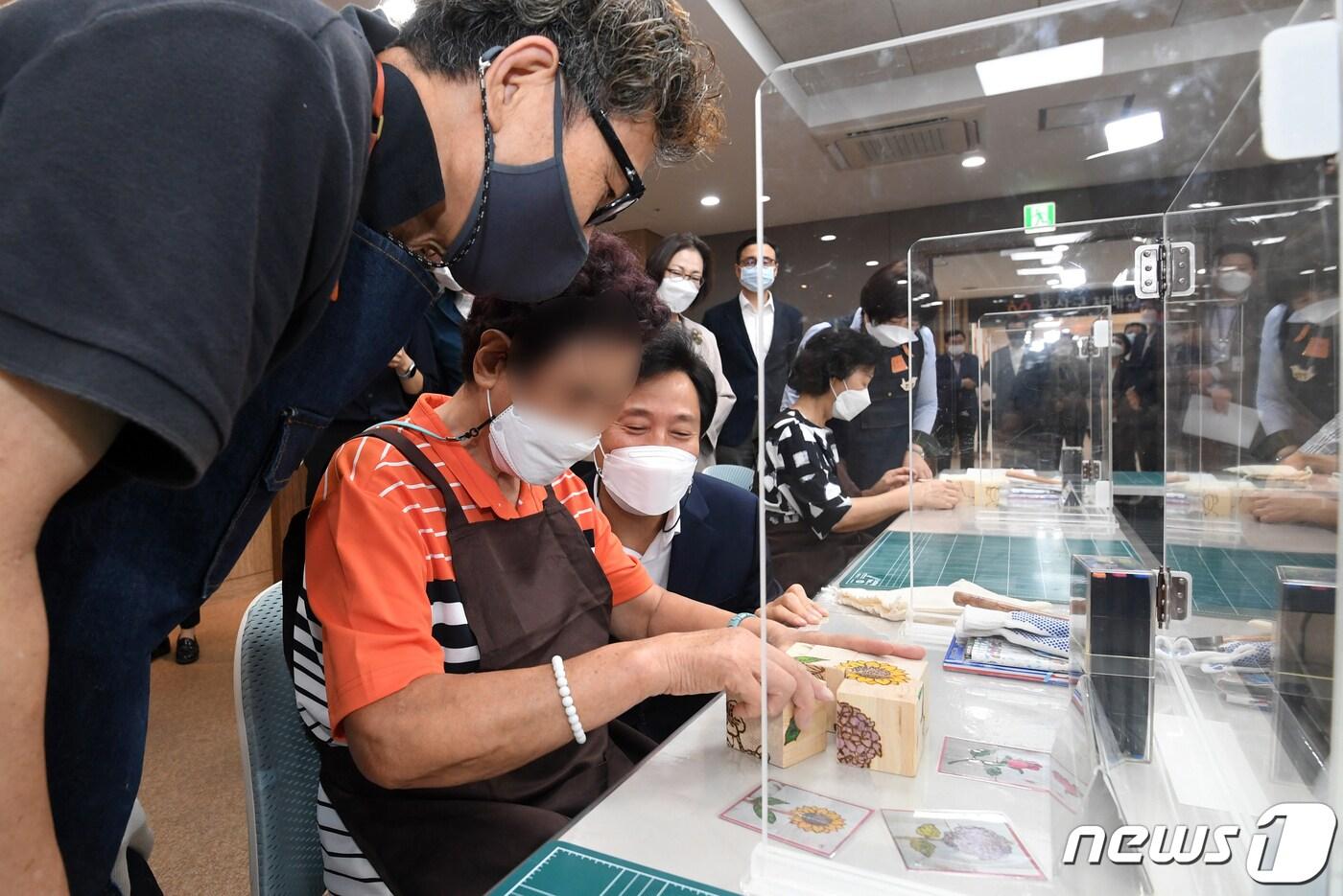 오세훈 서울시장이 17일 용산구 치매안심센터를 방문해 치매 어르신과 대화를 나누고 있다(서울시 제공).ⓒ 뉴스1