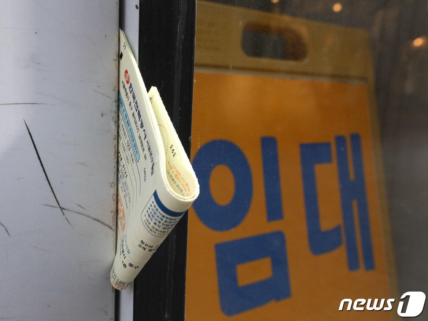 본문 이미지 - 서울 중구 명동거리의 한 상가의 폐업 안내 옆 전기 고지서가 놓여 있다. 뉴스1 ⓒ News1 신웅수 기자