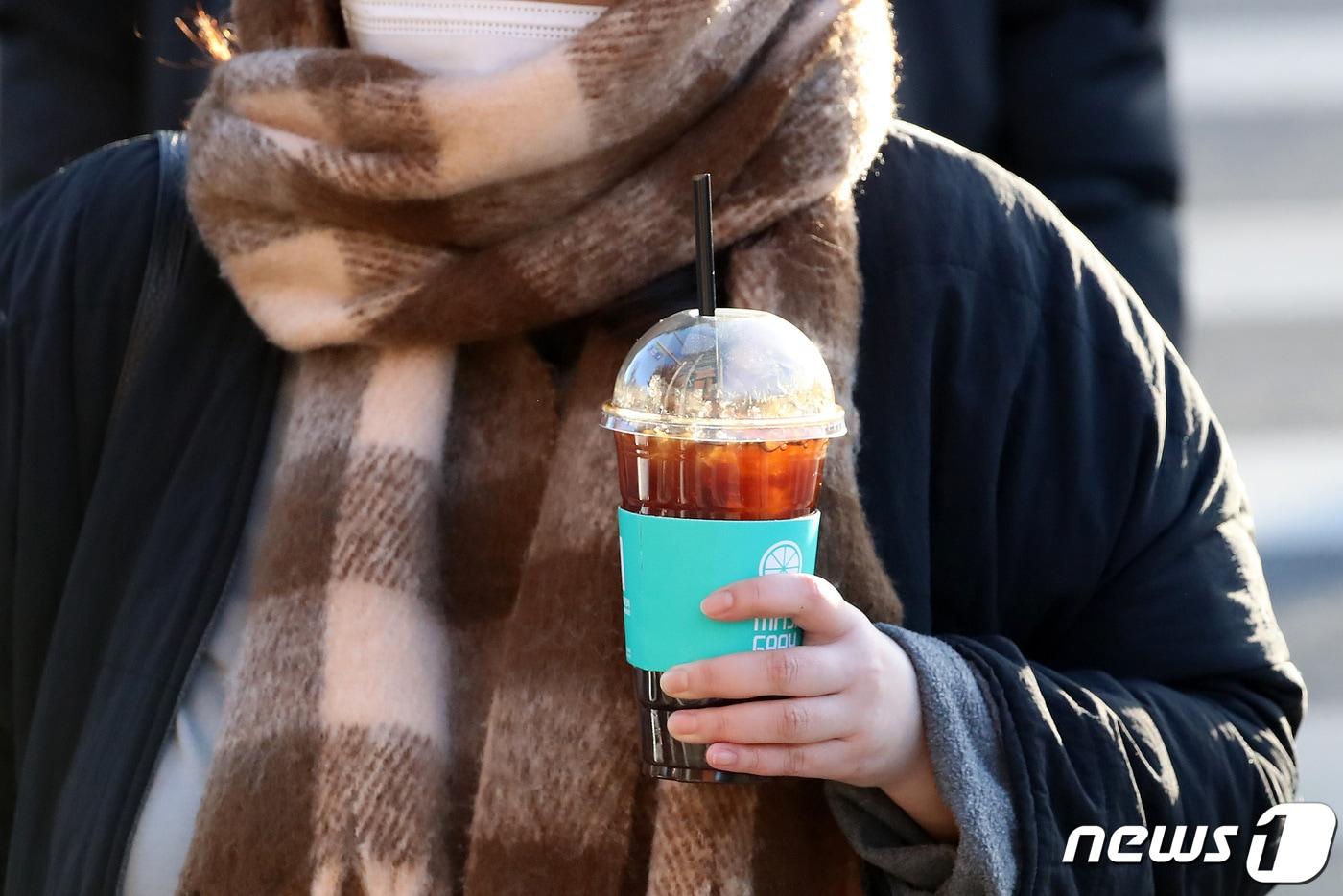 대구 중구 한 횡단보도에서 얼음이 가득 담긴 커피를 손에 든 시민이 출근길 발걸음을 옮기고 있다. /뉴스1 ⓒ News1 