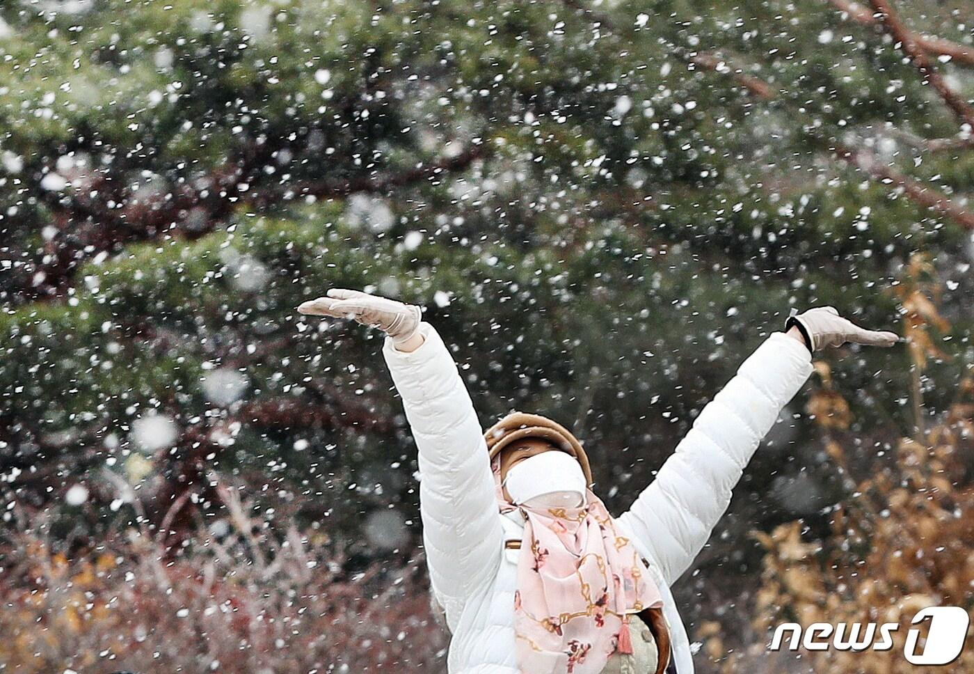 본문 이미지 - 서울을 비롯한 중부 지방에 대설주의보가 내려진 15일 서울 경복궁을 찾은 외국인 관광객들이 내리는 눈을 맞으며 즐거워 하고 있다.  2022.12.15/뉴스1 ⓒ News1 신웅수 기자