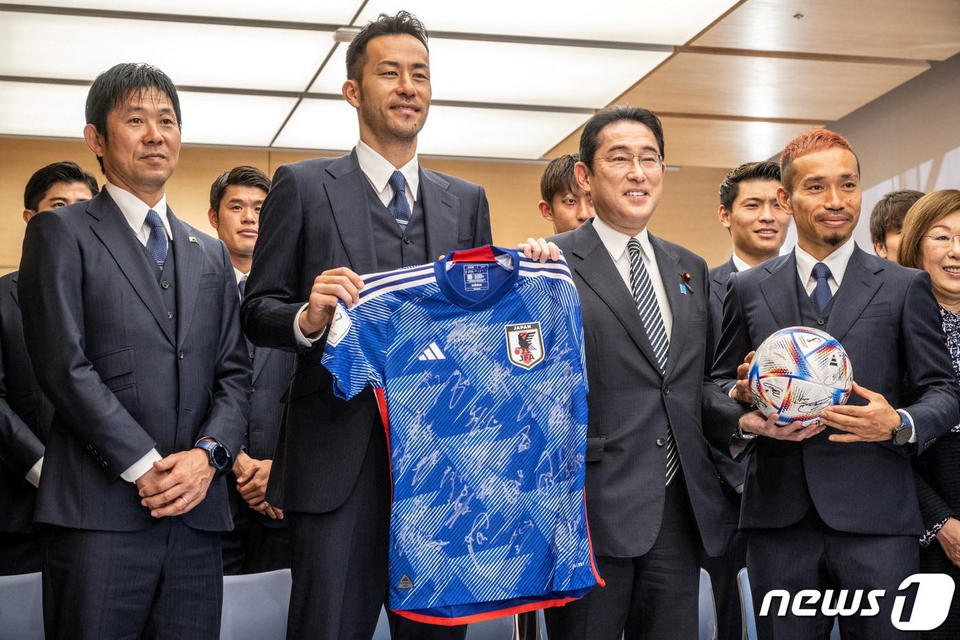 본문 이미지 - 8일 일본 도쿄 총리 관저에서 일본 축구 국가대표팀 선수들이 기시다 후미오 총리와 함께 사진을 찍고 있다. 일본팀은 2022 카타르 월드컵에서 16강에 올랐지만 크로아티아에 패했다. 왼쪽부터 모리야스 하지메 감독, 요시다 마야 선수, 기시다 총리, 나가토모 유토 선수. ⓒ 로이터=뉴스1 ⓒ News1 권진영 기자