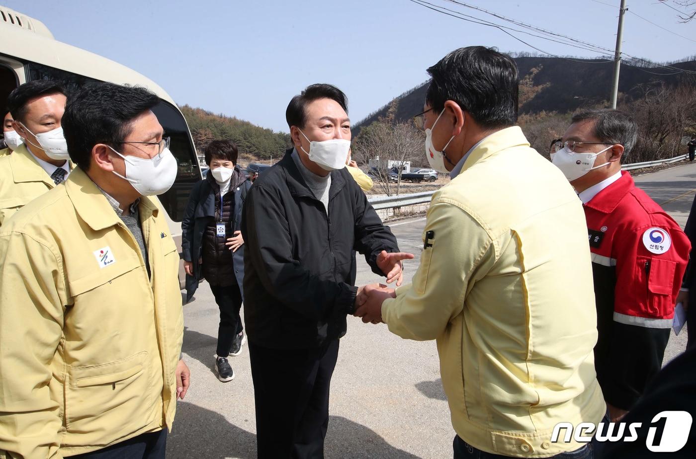 본문 이미지 - 윤석열 대통령 당선인이 15일 경북 울진군 북면 검성리 산불피해현장을 방문해 전찬걸 울진군수와 인사하고 있다. 2022.3.15/뉴스1 ⓒ News1 국회사진취재단