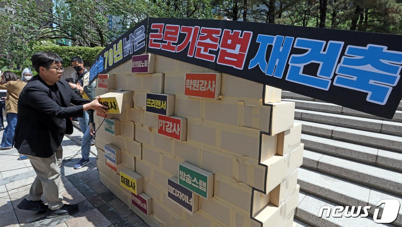 본문 이미지 - 직장갑질119 회원들이 10일 서울 중구 파이낸스빌딩에서 '70년 낡은 근로기준법 재건축 선포식'기자회견을 갖고 근로기준법 개정을 촉구하는 퍼포먼스를 하고 있다. 2022.5.10/뉴스1 ⓒ News1 장수영 기자