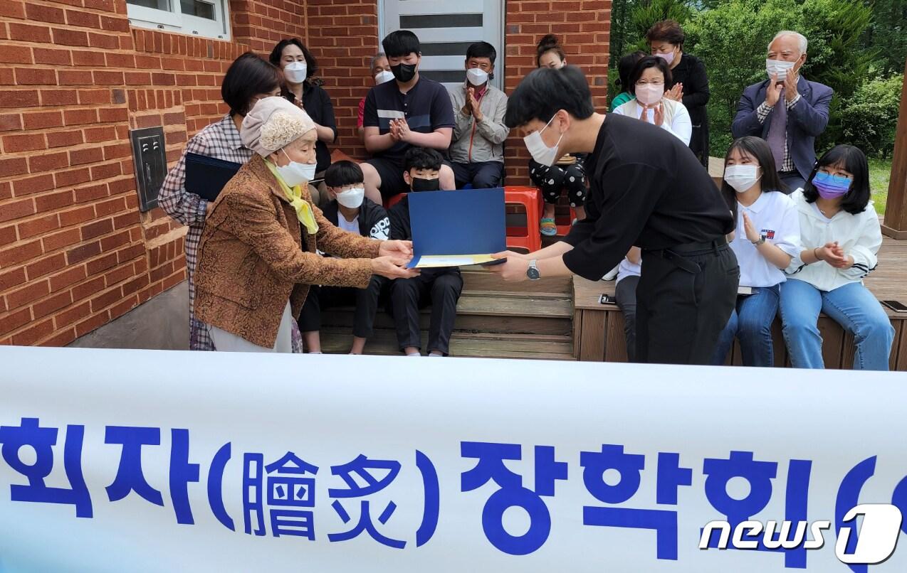본문 이미지 - 평생 모은 전 재산 기부 성주 박자연 할머니가 가천중학교 학생들에게 장학금을 전달하고 있다. (성주군 제공)2022.5.23/ⓒ 뉴스1