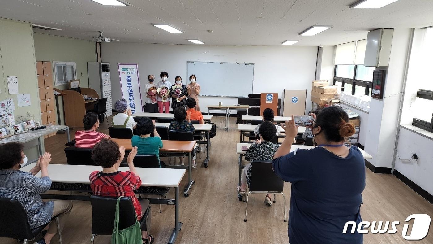 본문 이미지 - 8일 충북 충주열린학교는 교육생 남기옥씨가 전국 성인문해 백일장에서 최우수상을 받았다고 밝혔다. 사진은 같은반 동료의 수상을 축하해 주고 있는 충주열린학교 한글반 교육생들.(충주열린학교 제공)2022.7.8/ⓒ 뉴스1