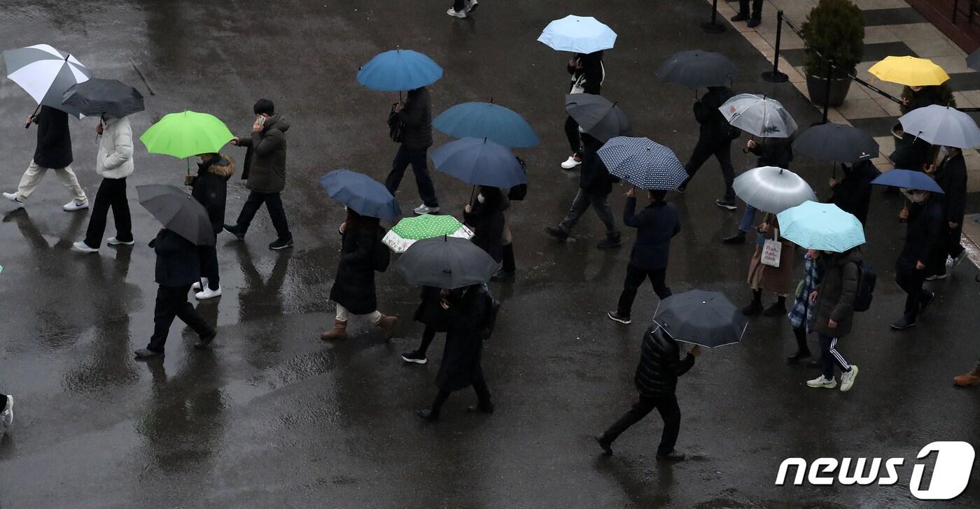 비가 내리는 13일 오전 서울역에서 우산을 쓴 시민들이 출근길을 재촉하고 있다. 2023.1.13/뉴스1 ⓒ News1 김진환 기자