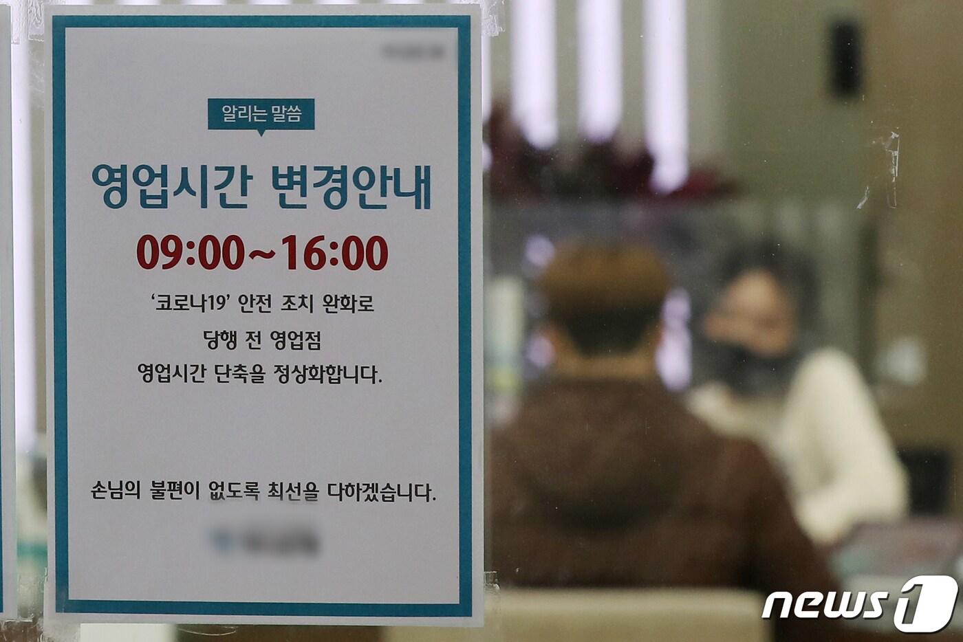은행 영업 시작 시간이 기존 오전 9시30분에서 9시로 복원된 30일 서울의 한 은행 영업점에 영업시간 변경을 알리는 안내문이 게시돼 있다. 이날부터 주요 시중은행들이 신종 코로나바이러스 감염증(코로나19) 확산 방지를 위해 단축했던 영업점 운영시간을 오전 9시부터 오후 4시로 정상화한다. 2023.1.30/뉴스1 ⓒ News1 민경석 기자