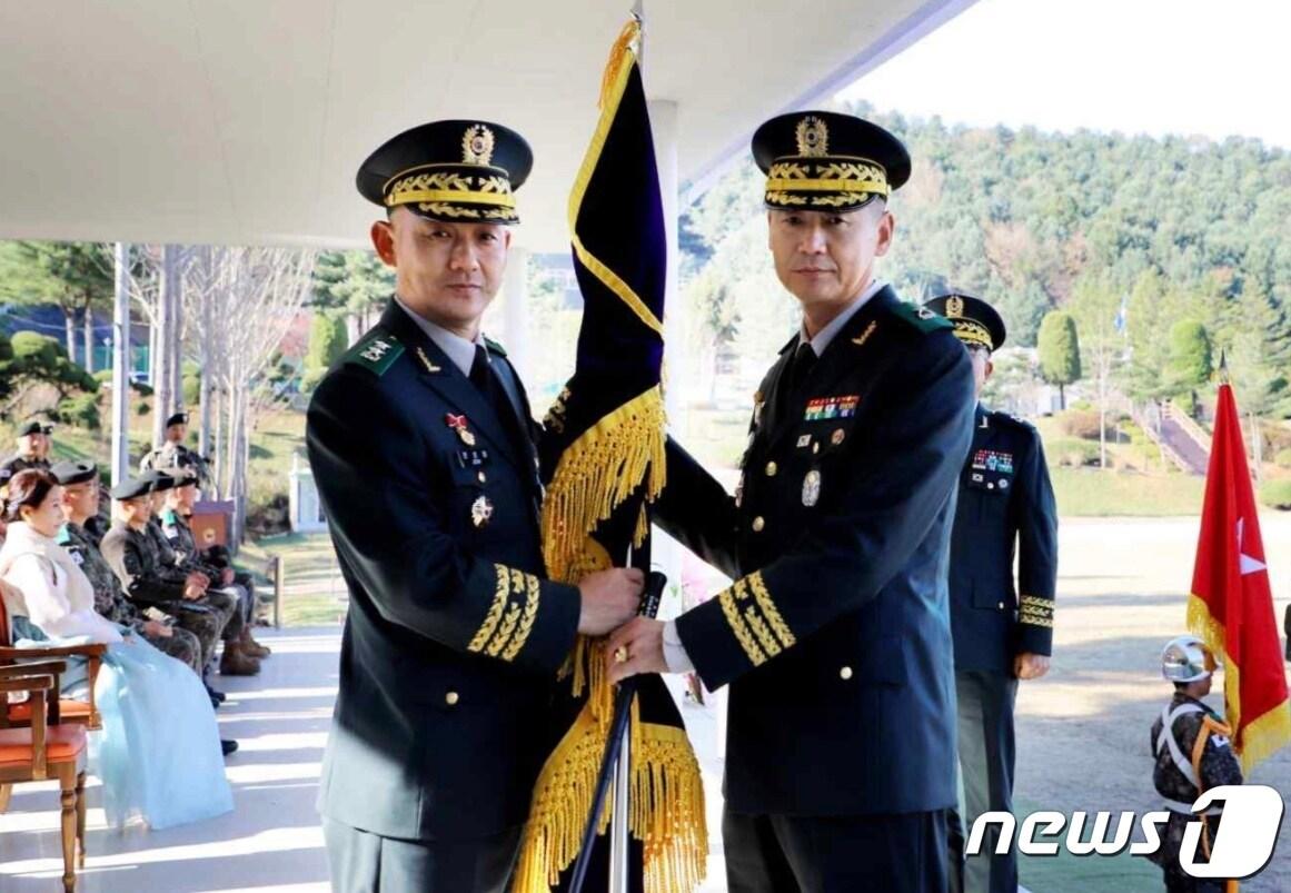 본문 이미지 - 13일 남양주 육군 제75보병사단에서 열린 사단장 이·취임식에서 전성대 동원전력사령관이 박동국 신임 75사단장(오른쪽)에게 부대기를 이양하고 있다.