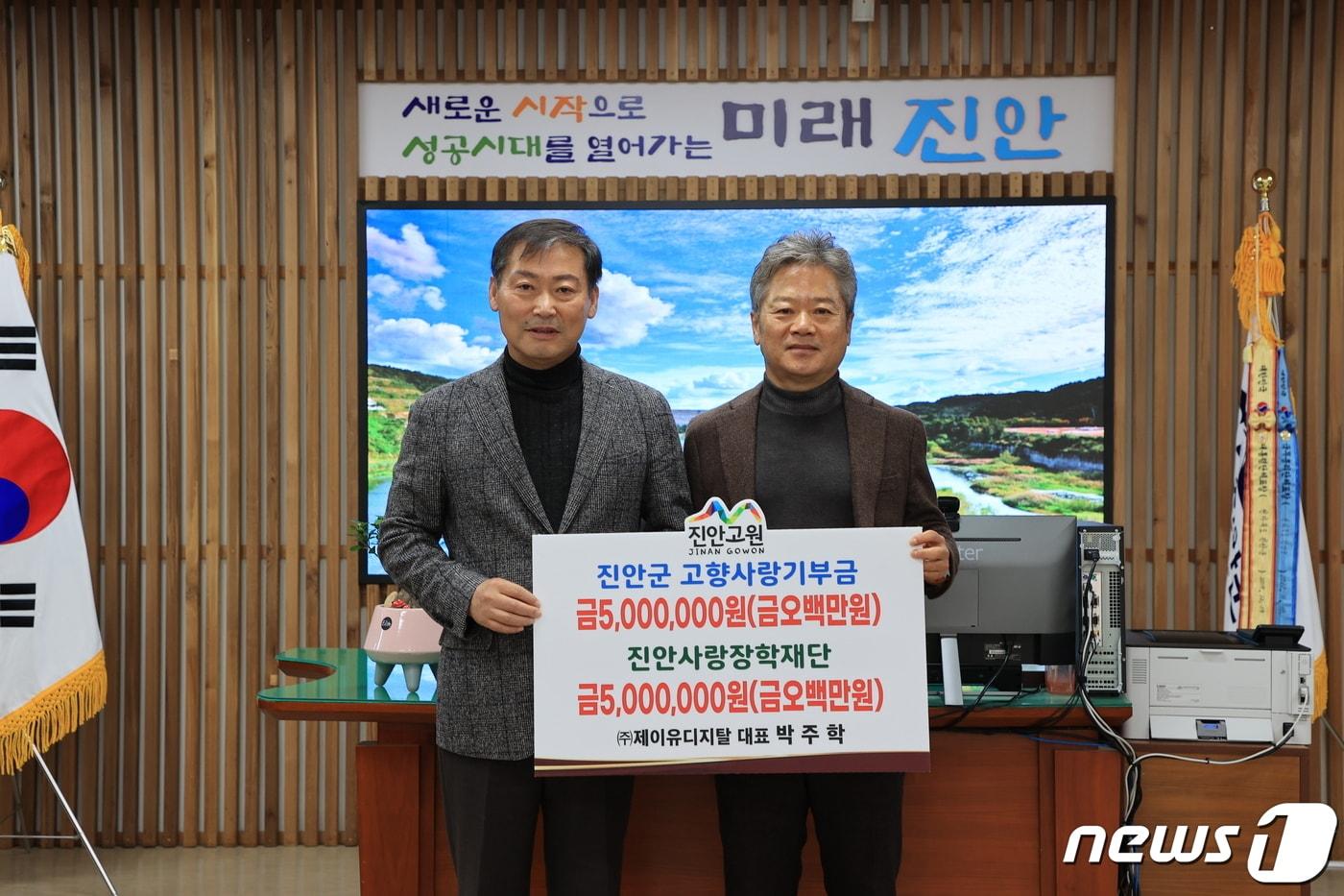 본문 이미지 - 23일 박주학 ㈜제이유디지탈 대표(오른쪽)가 전춘성 전북 진안군수에게 1000만원을 기탁하고 있다.(진안군제공)2023.11.23/뉴스1