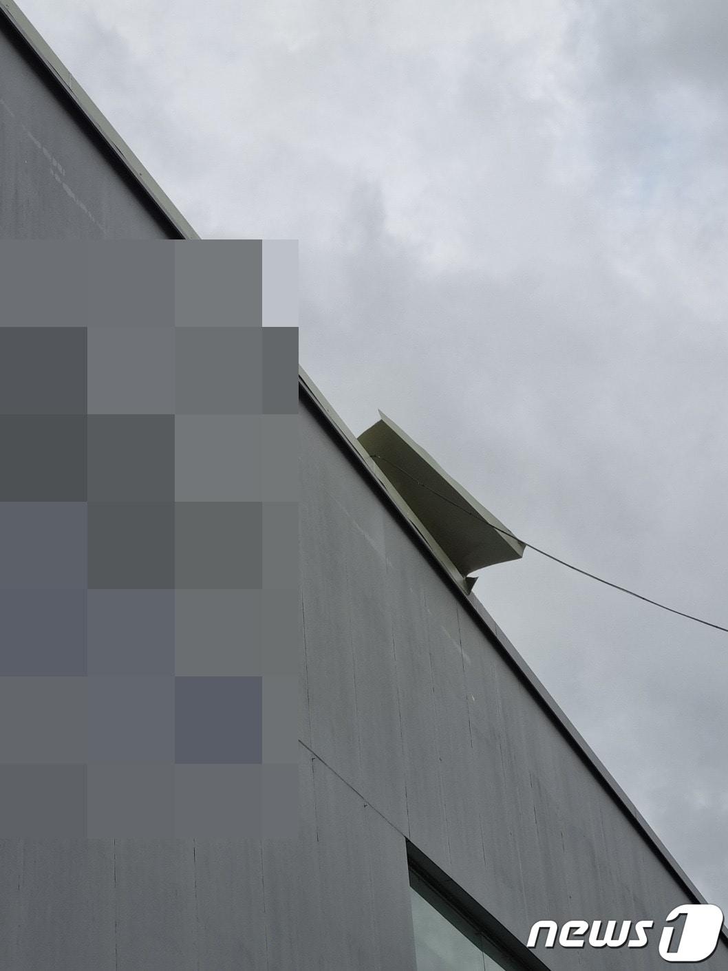 본문 이미지 - 6일 오전 7시17분쯤 충북 진천군 진천읍 성석리의 한 전자제품 판매점에서 강풍으로 뜯어진 지붕의 철재 구조물이 매달려있다.(충북소방본부 제공).2023.11.6./뉴스1