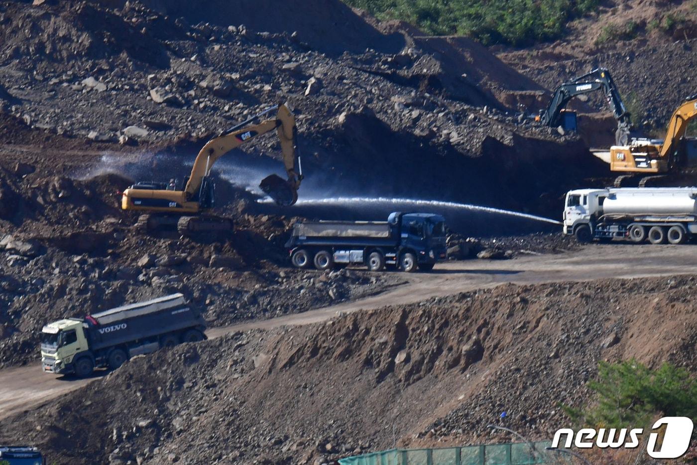 본문 이미지 - 한 공사장 관계자들이 비산먼지 발생에 대비해 살수차로 물을 뿌리고 있다. (자료사진) /뉴스1 ⓒ News1 