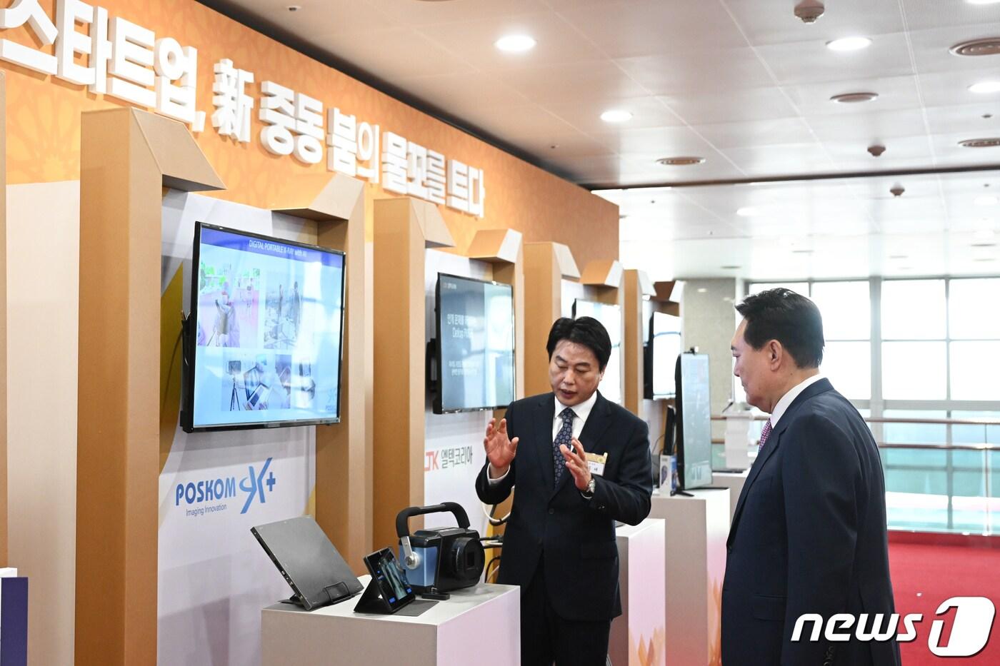 윤석열 대통령이 24일 용산 대통령실에서 UAE 순방 성과 중소기업인과의 대화에 앞서 포스콤 부스를 찾아 박종래 대표로부터 휴대용 엑스레이에 대한 설명을 듣고 있다. (대통령실 제공) 2023.2.24/뉴스1 ⓒ News1 안은나 기자