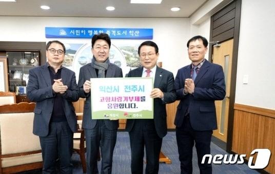 본문 이미지 - 우범기 전주시장과 정헌율 익산시장이 24일 익산시청에서 건전한 기부문화 활성화와 교류·협력 사업의 추진을 약속하면서 상호 지역에 고향사랑기부금을 전달했다.(전주시 제공) 2023.2.24/뉴스1