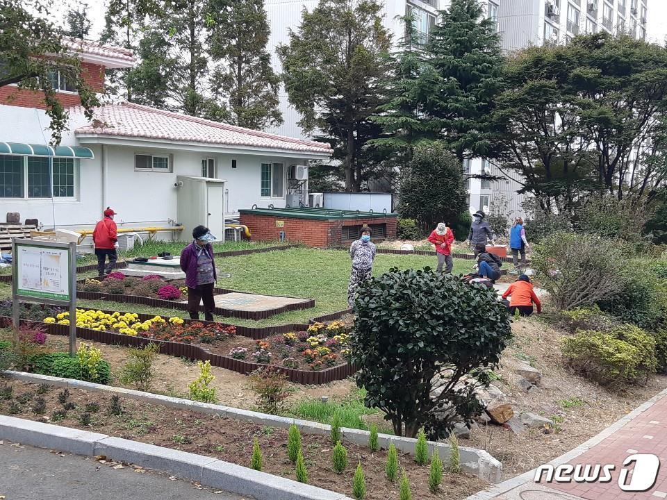 본문 이미지 - 최우수를 수상한 주공아파트 주민들이 단지 내에 꽃을 심고 있다(부산시청 제공) 