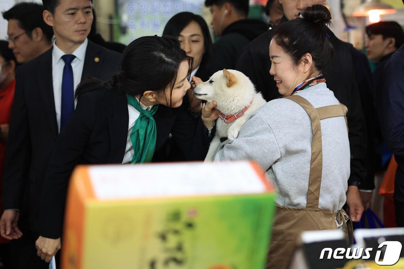 본문 이미지 - 김건희 여사가 지난 4월14일 대전 중구 태평전통시장을 방문해 한 상인이 키우는 유기견 로또와 인사하며 뽀뽀하고 있다. (대통령실 제공) 2023.4.14/뉴스1 ⓒ News1 안은나 기자