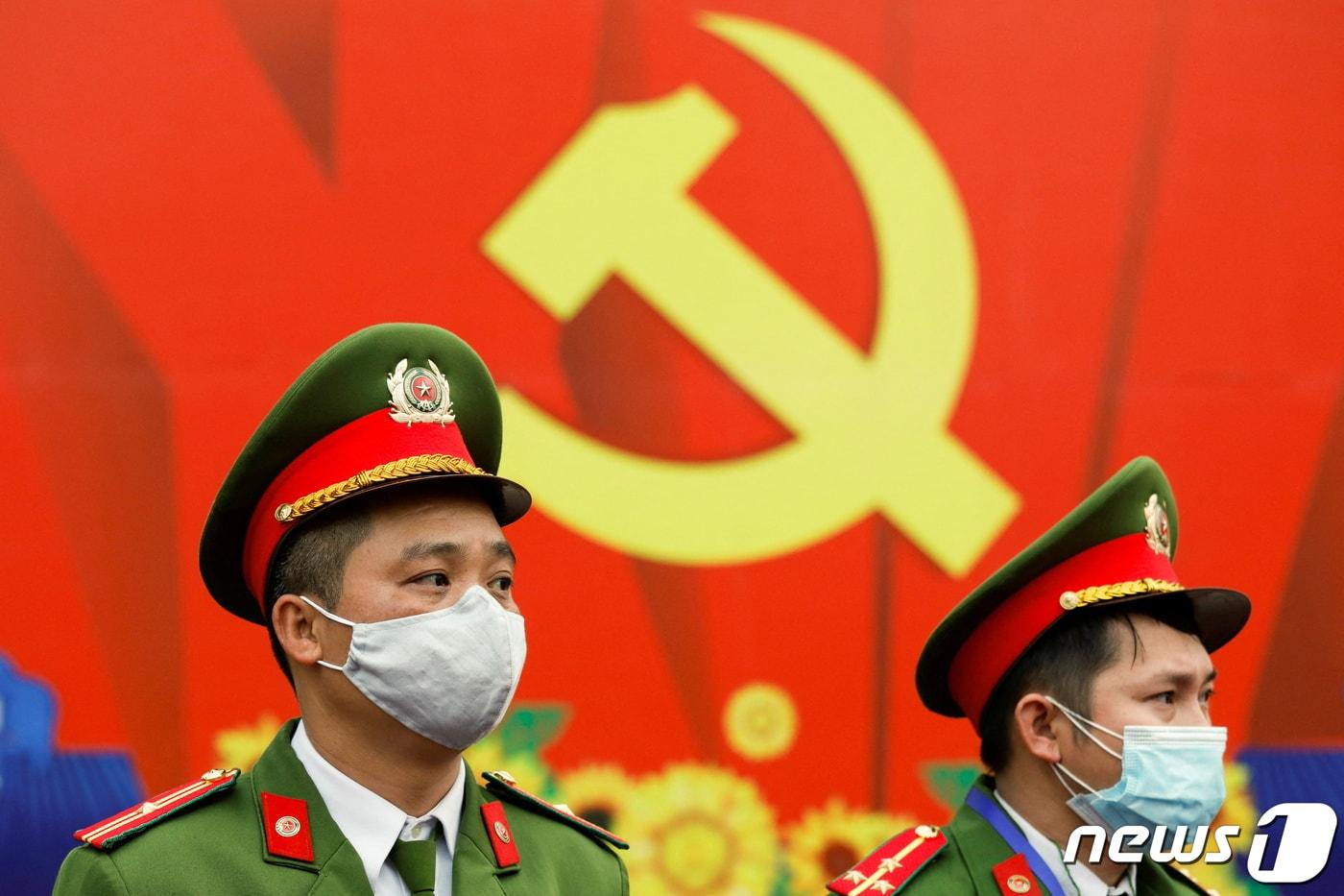본문 이미지 - 제13차 베트남 공산당 전국대표회의(전당대회)에서 경찰관들이 코로나19 예방 차원에서 마스크를 쓰고 경계를 서고 있다. 2021.01.28/뉴스1 ⓒ 로이터=뉴스1 ⓒ News1 김민수 기자