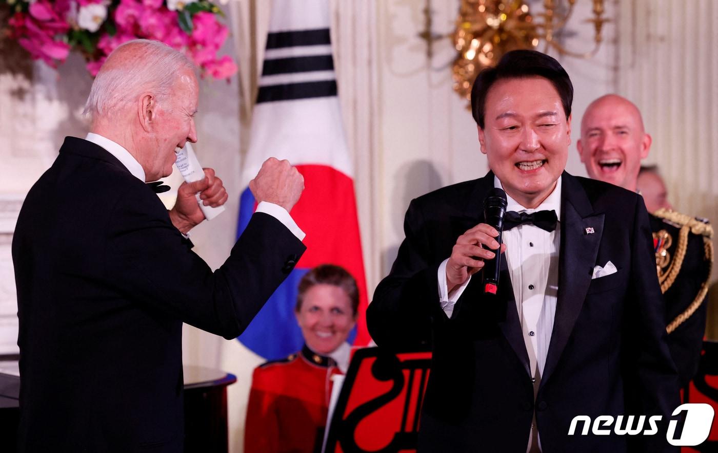 본문 이미지 - 미국을 국빈 방문한 윤석열 대통령이 26일(현지시간) 워싱턴 DC 백악관에서 열린 국빈만찬에서 마이크를 잡고 노래를 부르자 조 바이든 미국 대통령이 어깨춤을 추며 흥겨워 하고 있다. ⓒ 로이터=뉴스1 ⓒ News1 김성식 기자