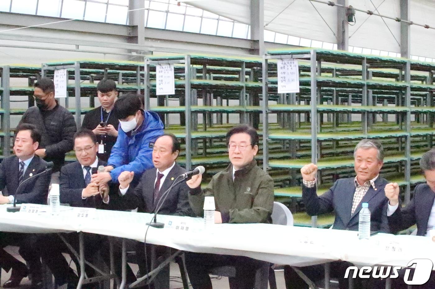 본문 이미지 - 이재명 더불어민주당 대표가 7일 전남 나주시 노안농협육묘장에서 열린 양곡관리법 재추진 결의를 위한 농민 간담회에서 농민들과 양곡관리법 재추진을 결의하고 있다. 2023.4.7/뉴스1 ⓒ News1 최성국 기자