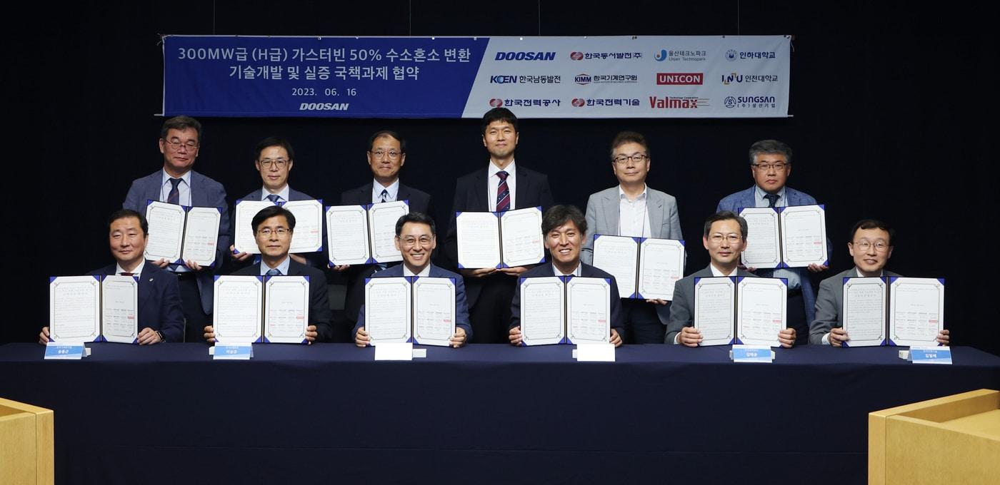 본문 이미지 - 경기도 성남시 분당두산타워에서 열린 ‘H급 대형 가스터빈 50% 수소혼소 기술 개발 및 실증 국책과제’ 협약식에서 참석자들이 기념촬영을 하고 있다.(두산에너빌리티 제공)