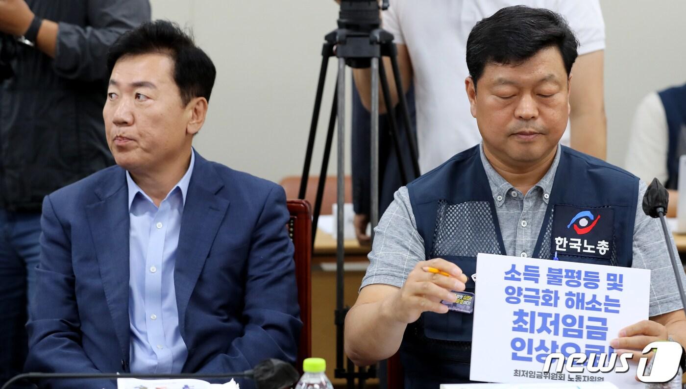 본문 이미지 - 최저임금위원회 근로자위원인 류기섭 한국노총 사무총장이 22일 정부세종청사에서 열린 최저임금위원회 제7차 전원회의에서 최저임금 인상 요구 피켓을 들어보이자 사용자위원인 류기정 경총 전무가 외면하고 있다. 한편 근로자위원은 이날 2024년도 최저임금 최초요구안으로 1만2210원을 제시했다. 2023.6.22/뉴스1 ⓒ News1 장수영 기자