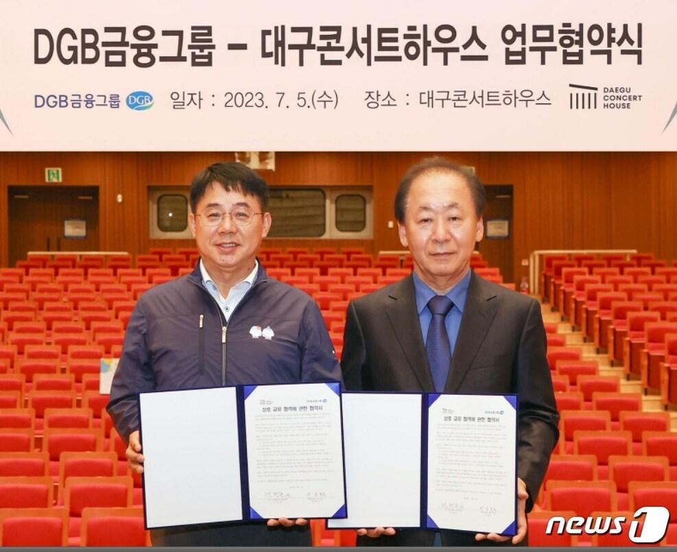 본문 이미지 - 5일 박창근 대구콘서트하우스 관장(오른쪽)과 김철호 DGB금융지주 그룹지속가능경영총괄 전무가 문화콘텐츠 개발 및 문화예술교육사업 지원을 위한 업무협약을 체결한 뒤 협약서를 펼쳐 보이고 있다.(대구은행 제공)