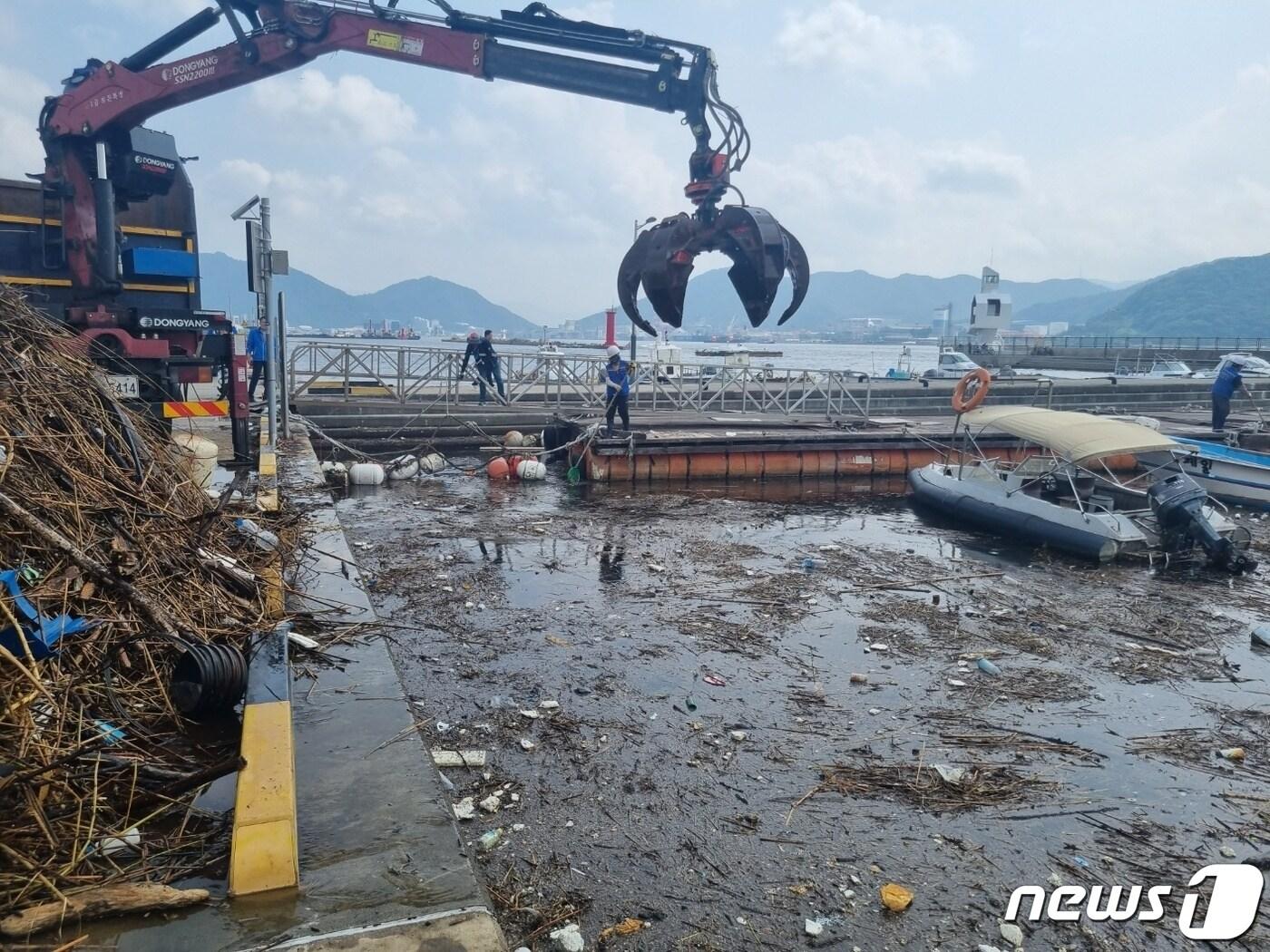 본문 이미지 - 마산항에서 해양쓰레기를 수거하고 있는 집게차 모습(창원시 제공).