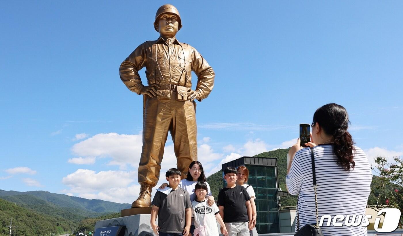 본문 이미지 - 다부동전적기념관을 찾은 가족 단위 관람객이 12일 백선엽 장군 동상을 배경으로 기념촬영을 하고 있다.(칠곡군 제공) 2023.9.13/뉴스1