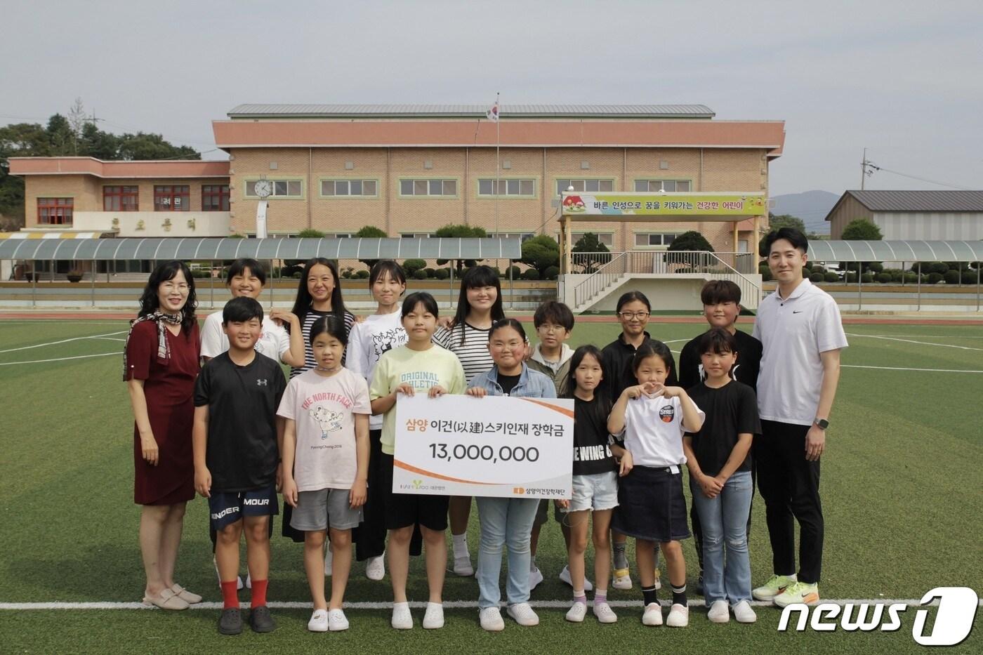 본문 이미지 - 강원특별자치도 평창군 대관령면 횡계초등학교 스키부 학생들과 선생님이 기념 촬영을 하고 있다.(삼양식품 제공)