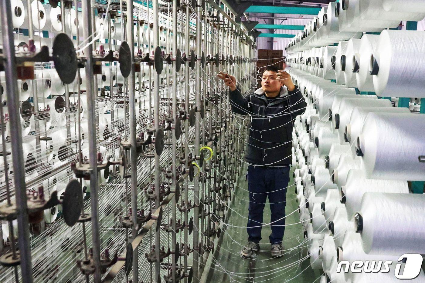본문 이미지 - 중국 동부 장수성 롄윈강 소재 카페트 공장에서 직원이 일하고 있다. 2024.1.17ⓒ AFP=뉴스1