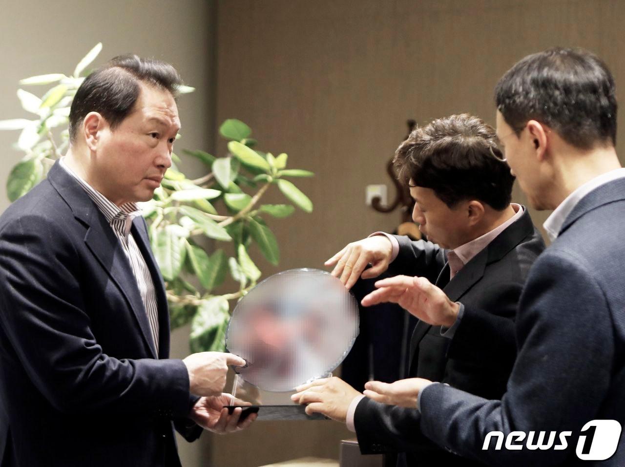 본문 이미지 - 최태원 SK그룹 회장이 4일 SK하이닉스 이천캠퍼스 R&D센터에서 곽노정 SK하이닉스 대표이사 사장&#40;가운데&#41;로부터 HBM웨이퍼와 패키지에 대한 설명을 듣고 있다.&#40;SK그룹 제공&#41;