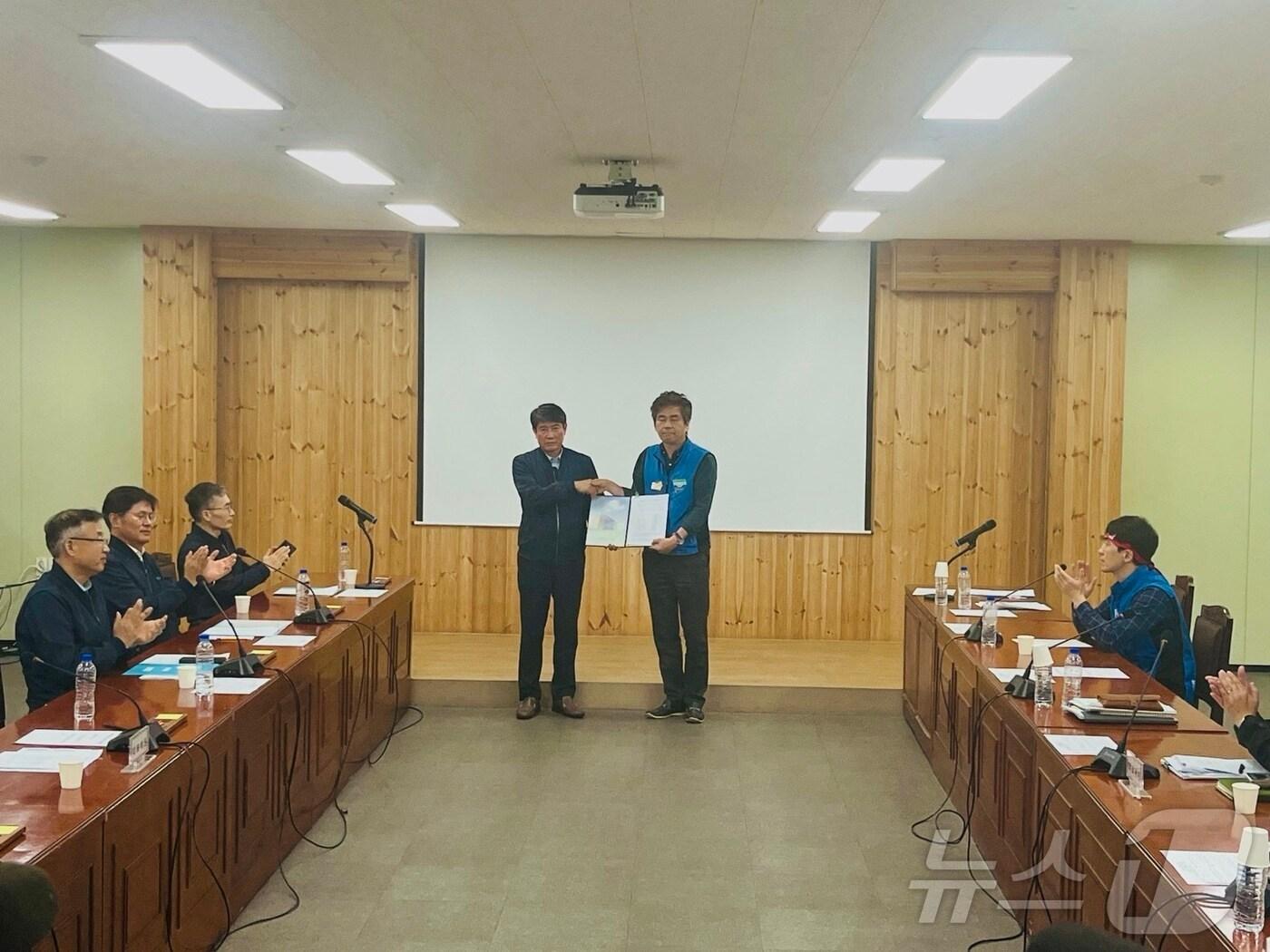 본문 이미지 - 10일 오후 부산 금정구 노포차량 사업소에서 박명도 부산교통공사 경영본부장&#40;왼쪽&#41;과 이상화 부산지하철노조 사무국장이 잠정 합의를 한 뒤 기념사진을 찍고 있다.2024.10.10/ⓒ News1 장광일 기자