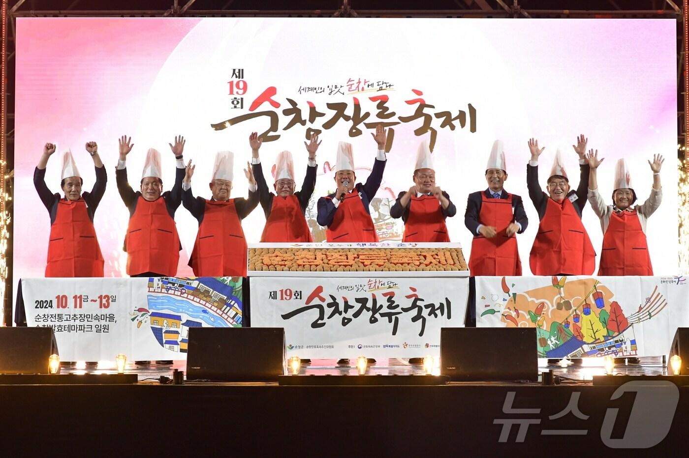 본문 이미지 - 고추장 상징의 붉은 앞치마를 입은 행사 참석자들이 제19회 순창장류축제 대성공을 기뻐하고 있다.(순창군 제공)/뉴스1 