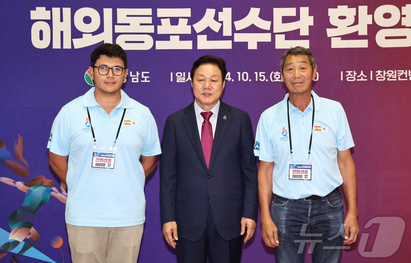 본문 이미지 - 자신의 친부모를 찾고 있는 니콜라스 데몬 스페인 해외동포 선수단장(오른쪽)과 이번 전국체전에 골프선수로 참가한 니콜라스 단장의 아들인 알렉스씨(왼쪽)가 박완수 지사와 사진을 촬영하고 있다.(경남도 제공)