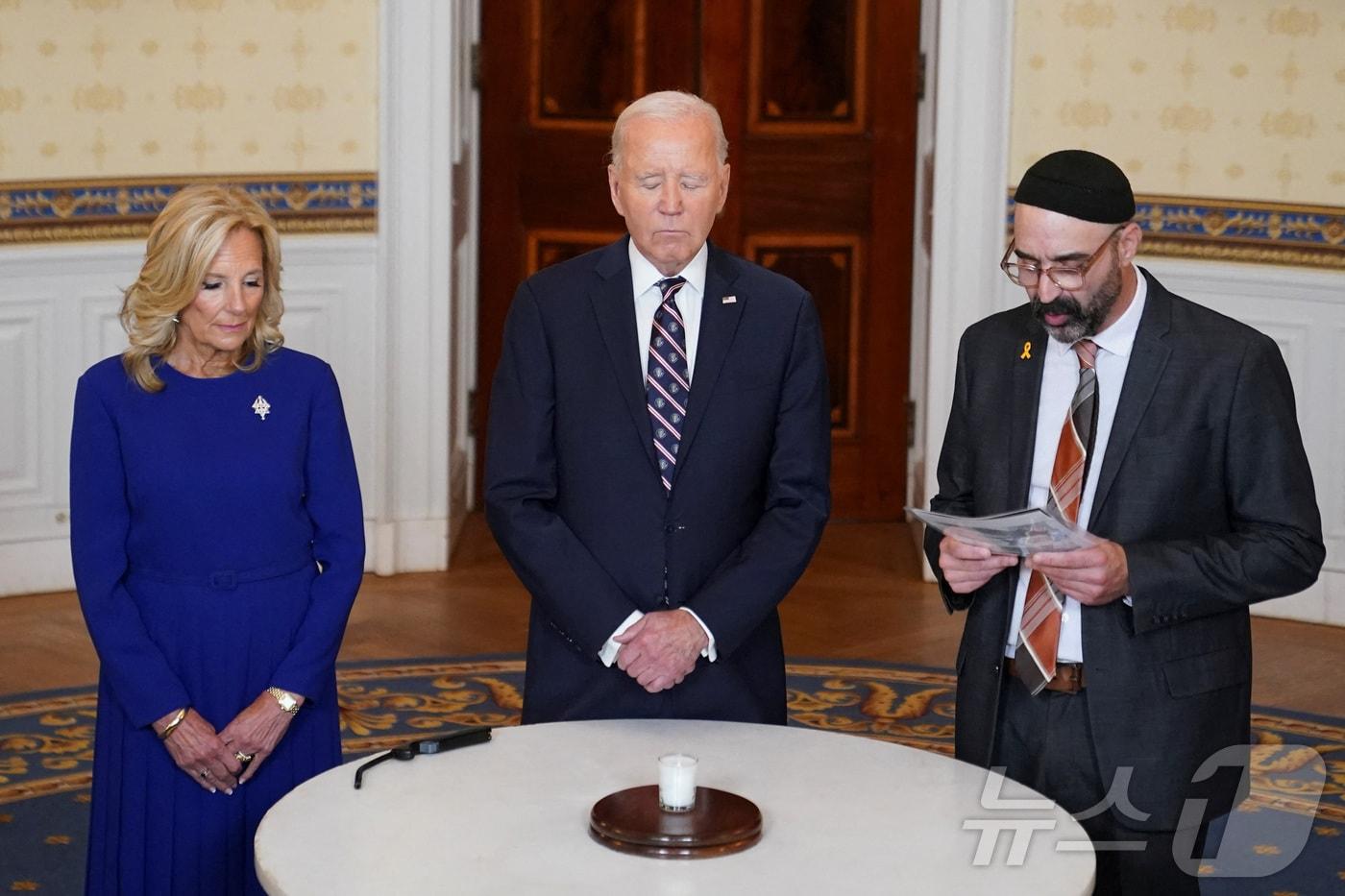 본문 이미지 - 조 바이든 미국 대통령이 7일 아내 질 여사와 함께 백악관에서 지난해 10월 7일 발생한 하마스의 이스라엘 공격 1년을 기념해 희생자들을 추모하고 있다. 2024.10.7 ⓒ 로이터=뉴스1 ⓒ News1 강민경 기자