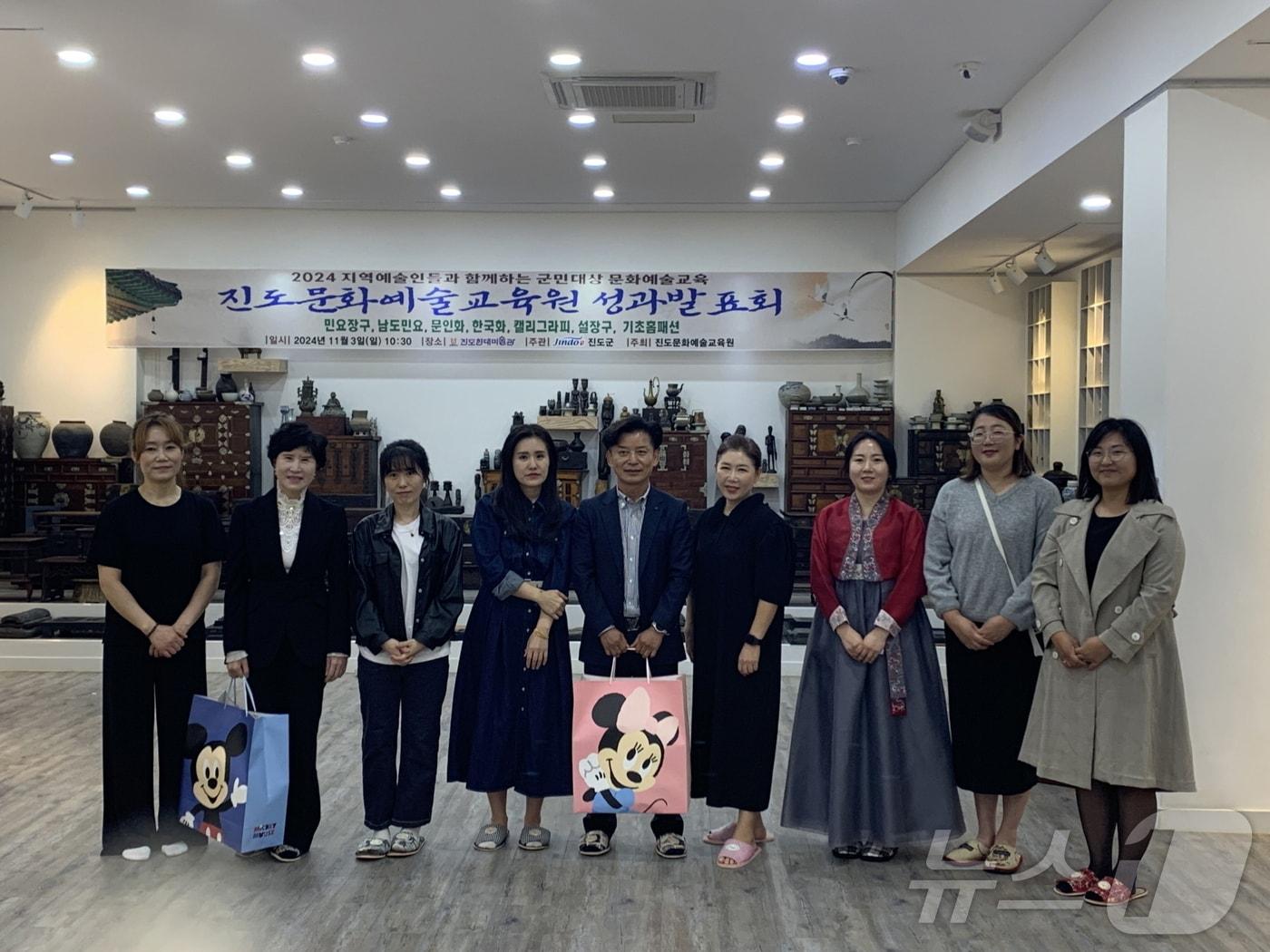 본문 이미지 - 진도군 문화예술교육원  '기초홈패션' 팀 수강생들이 진도보건소에 목도리를 전달한 뒤 기념사진을 찍고 있다.(진도군 제공)/뉴스1