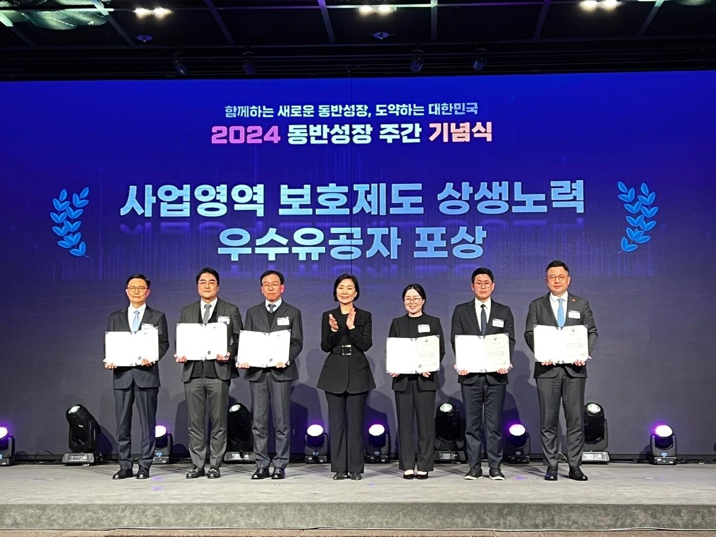 본문 이미지 - 윤홍립 신세계사이먼 개발·지원담당 상무(오른쪽 끝)가 26일 서울 여의도 중소기업중앙회에서 열린 2024년 동반성장 주간 기념식에서 중소벤처기업부 장관 표창을 받고 기념촬영을 하고 있다(신세계사이먼 제공).