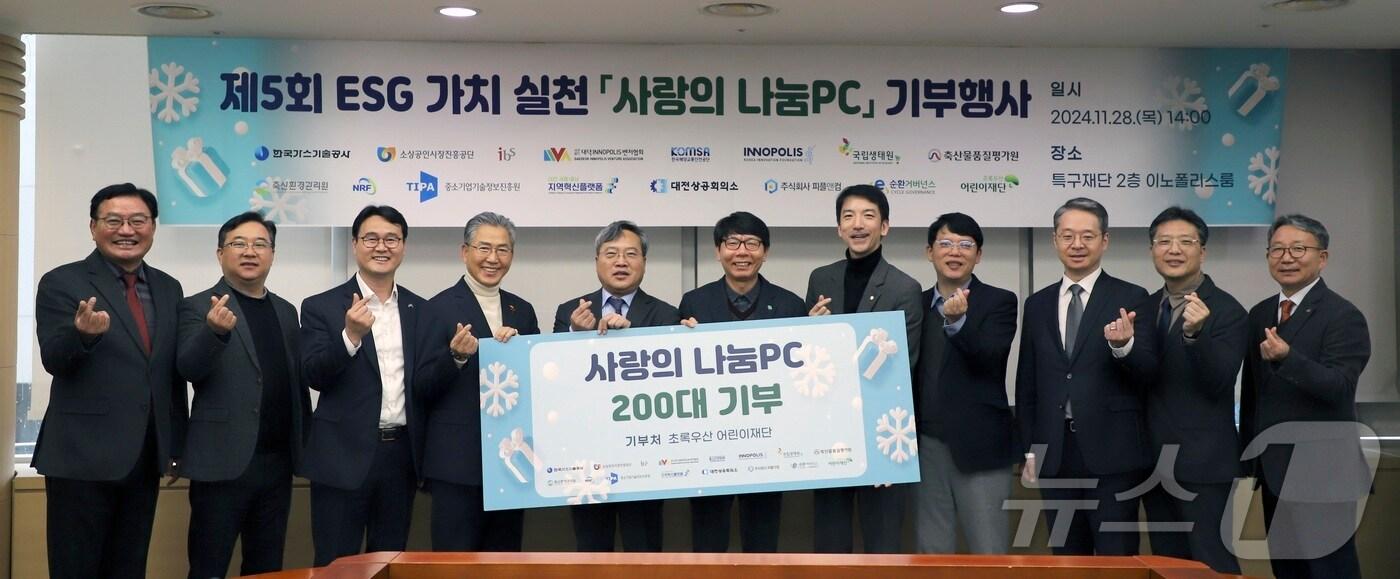 본문 이미지 - '사랑의 나눔PC 기부 행사'에 참가한 관계자들이 기념촬영을 하고 있다. (소상공인시장진흥공단 제공)