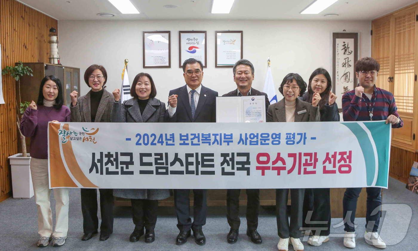 본문 이미지 - 김기웅 군수(왼쪽 네번째)와 드림스타트 관계자들이 전국 우수기관에 선정된 뒤 기념촬영을 하고 있다.(서천군 제공)/뉴스1