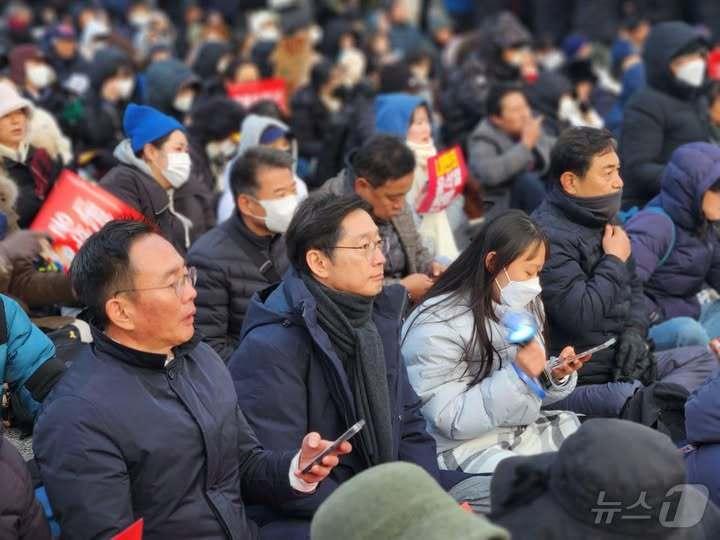 본문 이미지 -  김경수 전 경남지사&#40;왼쪽에서 2번째&#41; 가 지난 7일 오후 서울 여의도에서 열린 &#39;탄핵소추안 통과 기원 촛불집회&#39;에 참석한 모습. &#40;SNS 갈무리&#41; ⓒ 뉴스1