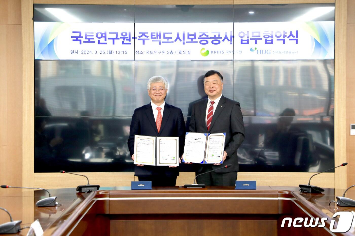 심교언 국토연구원장(왼쪽)과 유병태 HUG 사장이 25일 세종시 국토연구원 대회의실에서 업무협약식 후 기념사진을 찍고 있다.(주택도시보증공사 제공)