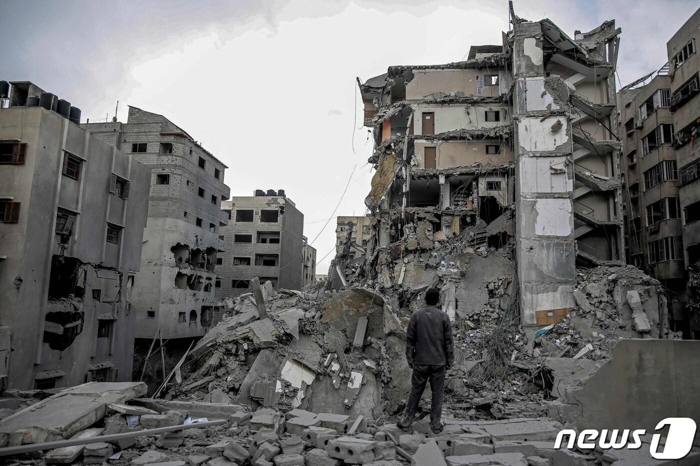 본문 이미지 - 지난 3일(현지시간) 가자지구에서 한 주민이 이스라엘과 팔레스타인 무장정파 하마스 사이에 벌어진 전쟁으로 폐허가 된 주택가 한가운데 서 있다. 2024.03.03/ ⓒ AFP=뉴스1 ⓒ News1 권진영 기자