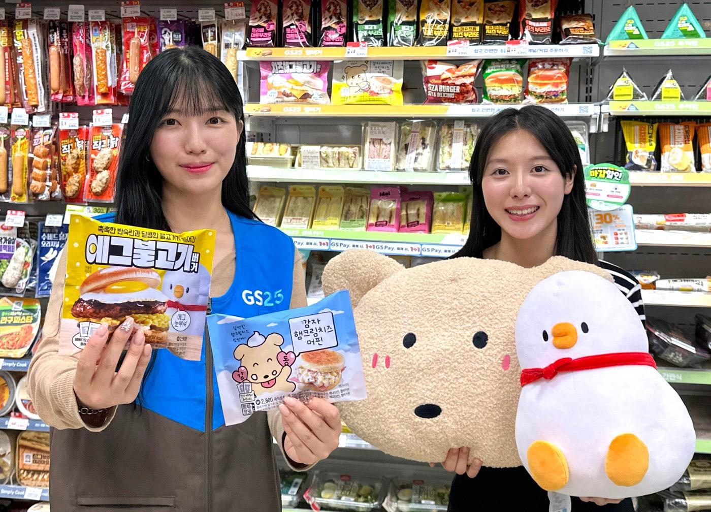 본문 이미지 - GS25에서 모델들이 캐릭터 제휴 먹거리 상품과 캐릭터 인형을 들고 포즈를 취하고 있다(GS리테일 제공).